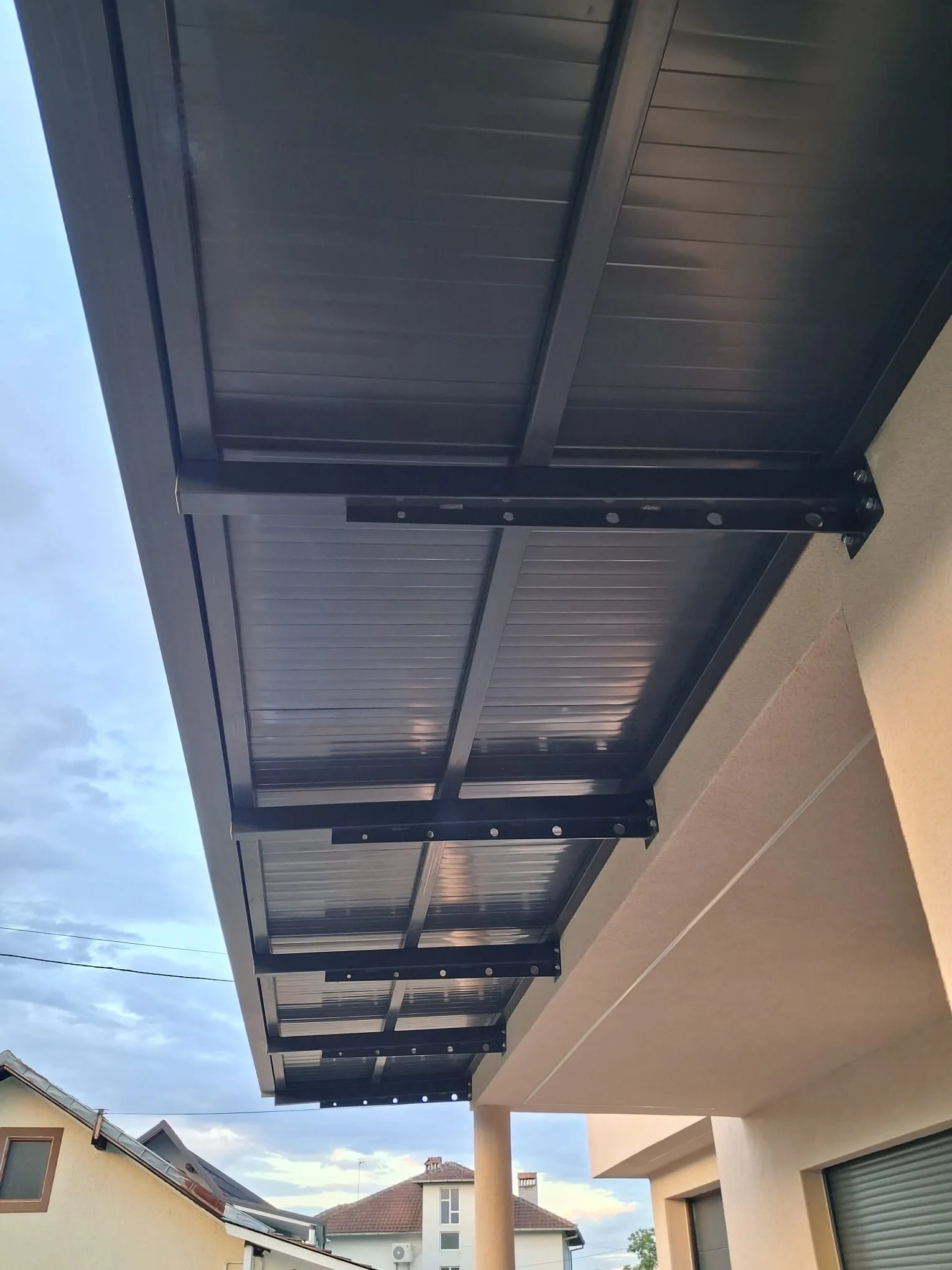 The underside of a steel canopy with polycarbonate roofing.